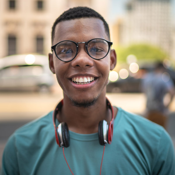 boy with headphones around his neck